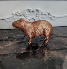 a brown bear figurine sitting on top of a table