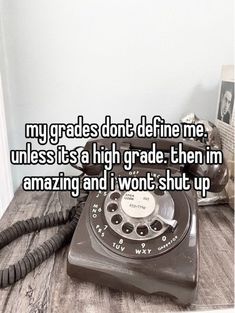 an old phone sitting on top of a wooden table