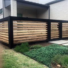 a wooden fence in front of a house