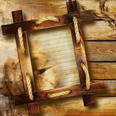 an old wooden frame with rope around it and a compass on the side, against a rustic wood background