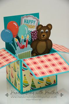 a birthday card with a teddy bear in a box