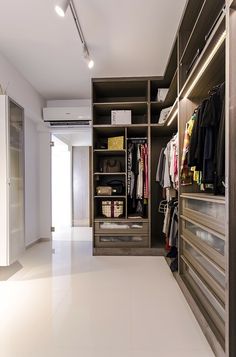 a walk in closet filled with lots of clothes