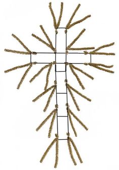 a cross made out of wheat stalks on a white background