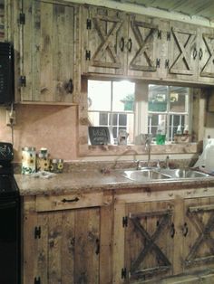 a kitchen with wooden cabinets and a black stove top oven