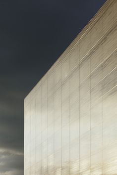 a tall building sitting under a cloudy sky