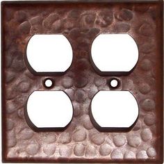 an old metal outlet cover with three holes