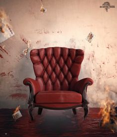 a red leather chair sitting in front of a wall with fire coming out of it