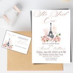 an open envelope with the eiffel tower in paris on it, next to some flowers