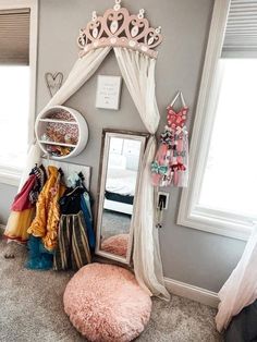 a room with a mirror, coat rack and other items on the floor in front of it