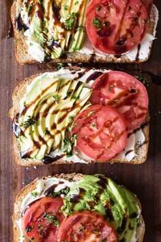 two slices of bread with avocado and tomatoes on them