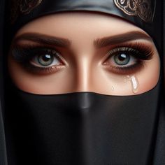 an image of a woman with blue eyes wearing a black head covering and veil over her face