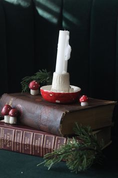 a candle is sitting on top of two books