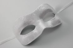 White masquerade mask decorated with white velvet fabric and satin ribbons. Masquerade masks made by Maskaku are a product of love for beauty and handicrafts.  All products are unique and entirely hand-made. Masks can cover your face but you are still guaranteed to stand out wearing one of them. They are ideally suited for a masked ball, costume party or a wedding gift. Many designs come in pairs both for him and for her in similar colors but unique shapes.  I'm sure you will find the one that s Elegant White Masquerade Mask, White Formal Masquerade Mask For Carnival, Elegant White Eye Mask, White Masks For Carnival Party, Elegant Party Eye Mask, White Party Masks For Carnival, Elegant White Party Masks And Prosthetics, White Carnival Party Mask, White Carnival Party Masks