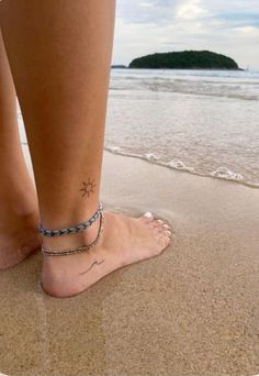 50 Best Small Travel Tattoos Ideas That Will Inspire Inner Wanderers | Aesthetic Travel Tattoos Ideas Tiny Sun And Wave Tattoo, Summer Ankle Tattoos, Small Tattoos Legs Women, Tiny Wave Tattoo Ankle, Tattoos To Get At The Beach, Sun And Wave Tattoo Ankle, Summer Sun Tattoo, Beachy Ankle Tattoos, Small Legs Tattoo