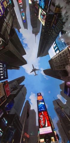 an airplane is flying through the sky between tall buildings