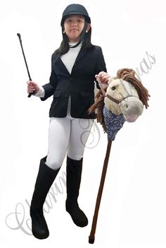 a woman is dressed in riding gear and holding a horse