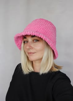 a woman with blonde hair wearing a pink hat