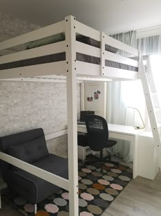 a loft bed with a desk underneath it and a chair under the bottom bunk beds