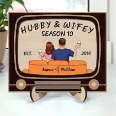 a couple sitting on a couch in front of a tv with the words hubby and wife season 10 written on it