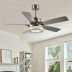 a living room with a fire place and a ceiling fan that has lights on it