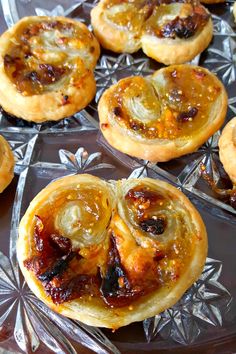 several small pastries sitting on top of a glass plate