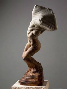 a sculpture is shown with its head in the air and it's body bent over