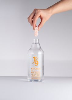 a hand is holding a bottle with something in it