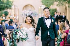 a bride and groom walking down the aisle