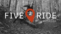 a man riding a bike down a dirt road in the woods with a red marker that says five 2 ride wisconsin usa