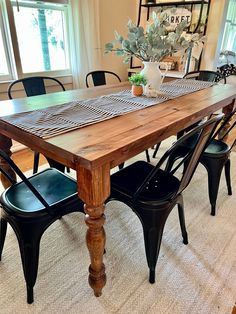 a wooden table with four chairs and a plant in the center is on sale for 40 % off