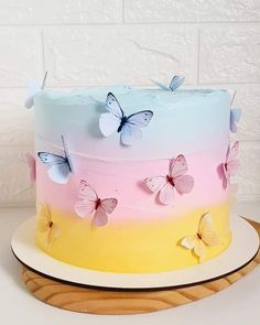 a multicolored cake with butterflies on it