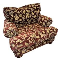 a red and gold patterned chair with pillows on it's back end, sitting in front of a white background