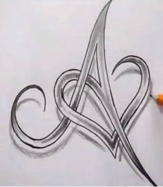 the letter a is drawn in pencil with a pen on top of it and an orange marker