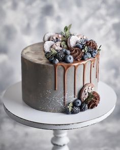 a cake with chocolate icing and berries on top