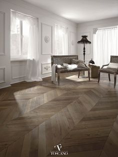 a living room with wood floors and white walls