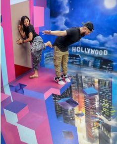 a man and woman standing on top of a fake city