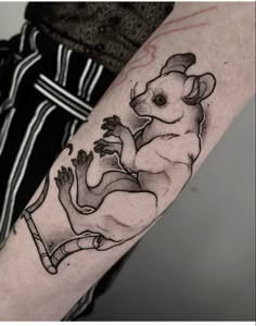 a black and white photo of a koala tattoo on the right arm with an outline of a kangaroo