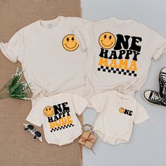 two shirts that say one happy mama, one happy dad with smiley faces on them