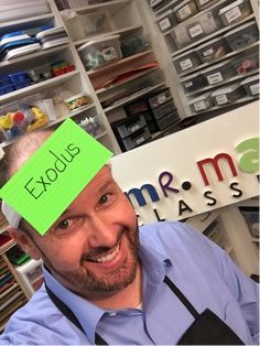 a man with a sticky note on his head