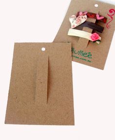 two pieces of brown paper with pink flowers on them