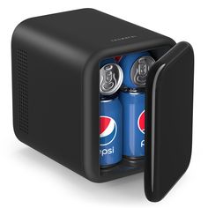 two soda cans in a black mini fridge