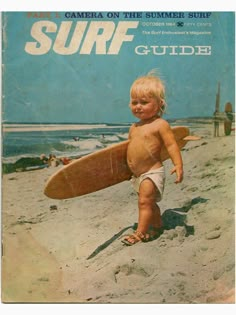 a young child holding a surfboard on the beach