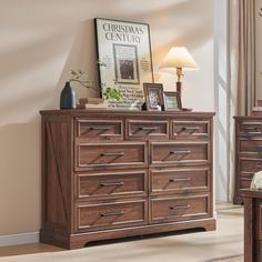 a wooden dresser sitting in a living room next to a lamp