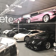 there are many cars on the shelves in this garage, and one car is black