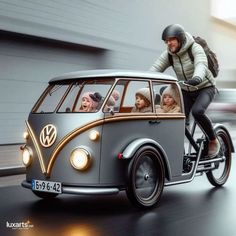 a man riding on the back of a gray and gold vw bus with people in it