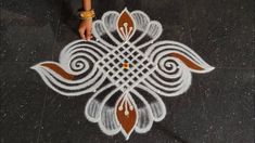 a person is standing on the ground with their hand in front of an intricate design