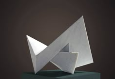 an abstract white sculpture sitting on top of a green pedestal with a black base and dark background