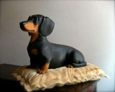 a black and brown dog figurine sitting on top of a table