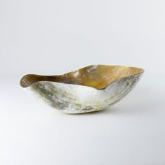 a white and brown bowl sitting on top of a table