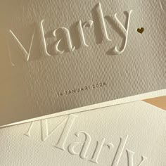 some type of business card with the word marry written on it in white and gold